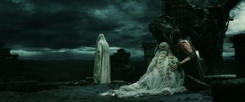 Movie still from “The Hobbit: The Battle of the Five Armies” (2014), directed by Peter Jackson – A woman in a long white dress and a man in a white robe; Wide shot, Over the shoulder angle