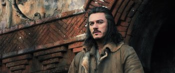 Movie still from “The Hobbit: The Battle of the Five Armies” (2014), directed by Peter Jackson – A person with long black hair; Close Up shot, Low angle