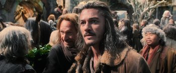 Movie still from “The Hobbit: The Battle of the Five Armies” (2014), directed by Peter Jackson – A man with long grey hair standing next to another man with long gray hair; Close Up shot, Over the shoulder angle