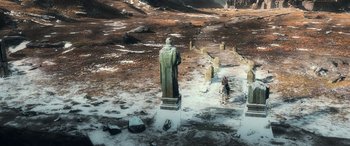 Movie still from “The Hobbit: The Battle of the Five Armies” (2014), directed by Peter Jackson – A man is standing in the middle of a snowy field; Extreme Wide shot, High angle