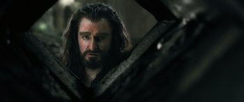 Movie still from “The Hobbit: The Battle of the Five Armies” (2014), directed by Peter Jackson – A man with long hair and a beard looking into a mirror; Close Up shot, Over the shoulder angle