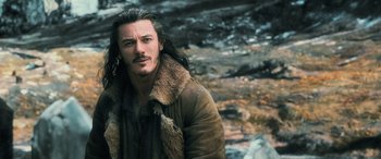 Movie still from “The Hobbit: The Battle of the Five Armies” (2014), directed by Peter Jackson – A person with long hair wearing a jacket; Close Up shot, Over the shoulder angle