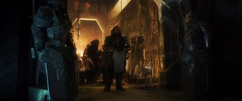 Movie still from “The Hobbit: The Battle of the Five Armies” (2014), directed by Peter Jackson – A group of people standing around in a room; Wide shot, Low angle