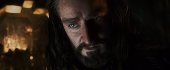 Movie still from “The Hobbit: The Battle of the Five Armies” (2014), directed by Peter Jackson – A person with long hair and a beard; Close Up shot, Low angle