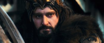 Movie still from “The Hobbit: The Battle of the Five Armies” (2014), directed by Peter Jackson – A person with a beard wearing a crown; Close Up shot, Over the shoulder angle