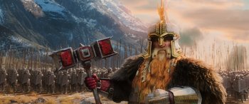 Movie still from “The Hobbit: The Battle of the Five Armies” (2014), directed by Peter Jackson – An image of a man with a beard holding a hammer; Medium shot, Low angle