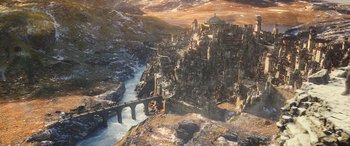 Movie still from “The Hobbit: The Battle of the Five Armies” (2014), directed by Peter Jackson – An aerial view of an ancient city with a river running through it; Extreme Wide shot, High angle