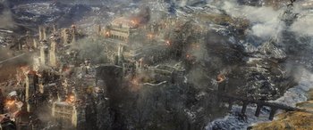Movie still from “The Hobbit: The Battle of the Five Armies” (2014), directed by Peter Jackson – An aerial view of a city on fire; Extreme Wide shot, High angle