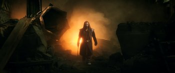 Movie still from “The Hobbit: The Battle of the Five Armies” (2014), directed by Peter Jackson – A man with a long hair and a long beard is holding a staff in his hand; Wide shot, High angle
