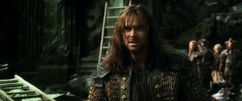 Movie still from “The Hobbit: The Battle of the Five Armies” (2014), directed by Peter Jackson – A person with long brown hair; Close Up shot, Low angle