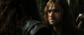 Movie still from “The Hobbit: The Battle of the Five Armies” (2014), directed by Peter Jackson – A person with long brown hair; Close Up shot, Over the shoulder angle