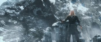 Movie still from “The Hobbit: The Battle of the Five Armies” (2014), directed by Peter Jackson – A woman is holding a sword in a snowy forest; Wide shot, Low angle
