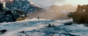 Movie still from “The Hobbit: The Battle of the Five Armies” (2014), directed by Peter Jackson – A man standing on top of an ice covered mountain; Extreme Wide shot, High angle