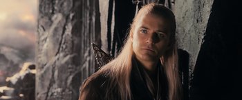 Movie still from “The Hobbit: The Battle of the Five Armies” (2014), directed by Peter Jackson – A person with long blonde hair; Close Up shot, Over the shoulder angle