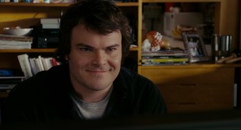 Movie still from “The Holiday” (2006), directed by Nancy Meyers – A man sitting in front of a computer monitor; Close Up shot, Over the shoulder angle