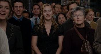Movie still from “The Holiday” (2006), directed by Nancy Meyers – A group of people standing in a room; Medium shot, Over the shoulder angle
