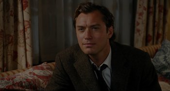Movie still from “The Holiday” (2006), directed by Nancy Meyers – A person wearing a suit and tie; Close Up shot, Over the shoulder angle