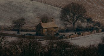 Movie still from “The Holiday” (2006), directed by Nancy Meyers – An old house in the middle of a snowy field; Extreme Wide shot, High angle