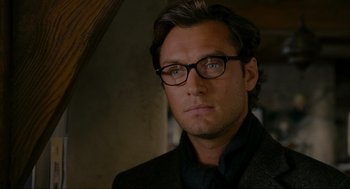 Movie still from “The Holiday” (2006), directed by Nancy Meyers – A person wearing glasses and a suit; Close Up shot, Over the shoulder angle
