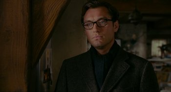 Movie still from “The Holiday” (2006), directed by Nancy Meyers – A person wearing glasses and a suit; Close Up shot, Over the shoulder angle