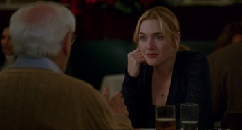Movie still from “The Holiday” (2006), directed by Nancy Meyers – A woman sitting in front of an older man at a table; Close Up shot, Over the shoulder angle
