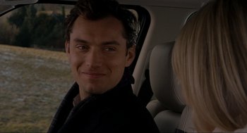 Movie still from “The Holiday” (2006), directed by Nancy Meyers – A man sitting in a car with a woman in the back seat; Close Up shot, Over the shoulder angle