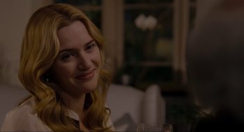 Movie still from “The Holiday” (2006), directed by Nancy Meyers – A woman sitting at a table with a glass of wine; Close Up shot, Over the shoulder angle