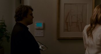 Movie still from “The Holiday” (2006), directed by Nancy Meyers – A man standing in front of a painting; Medium shot, Over the shoulder angle