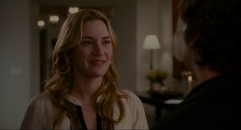 Movie still from “The Holiday” (2006), directed by Nancy Meyers – A woman with long blonde hair smiles at the camera; Close Up shot, Over the shoulder angle