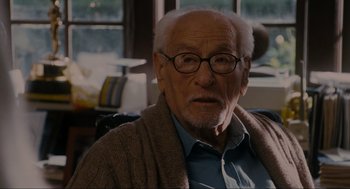 Movie still from “The Holiday” (2006), directed by Nancy Meyers – An older man with glasses and a sweater; Close Up shot, Over the shoulder angle