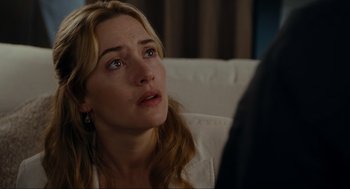 Movie still from “The Holiday” (2006), directed by Nancy Meyers – A person sitting on a couch; Close Up shot, Over the shoulder angle