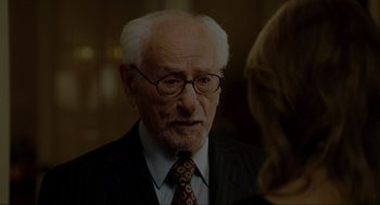 Movie still from “The Holiday” (2006), directed by Nancy Meyers – An older man wearing glasses and a suit and tie; Close Up shot, Over the shoulder angle