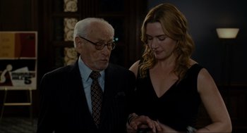 Movie still from “The Holiday” (2006), directed by Nancy Meyers – An older man and a younger woman looking at each other; Medium shot, Over the shoulder angle