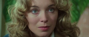 Movie still from “The House by the Cemetery” (1981), directed by Lucio Fulci – A woman's face with green eyes; Close Up shot, Over the shoulder angle