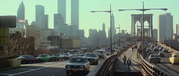 Movie still from “The House by the Cemetery” (1981), directed by Lucio Fulci – A city street filled with lots of traffic; Extreme Wide shot, High angle
