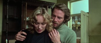 Movie still from “The House by the Cemetery” (1981), directed by Lucio Fulci – A man and a woman standing next to each other; Close Up shot, Low angle