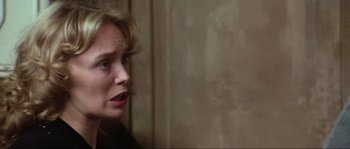 Movie still from “The House by the Cemetery” (1981), directed by Lucio Fulci – A person looking at the camera; Close Up shot, Over the shoulder angle