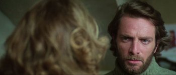 Movie still from “The House by the Cemetery” (1981), directed by Lucio Fulci – A man with a beard and a long beard; Close Up shot, Over the shoulder angle