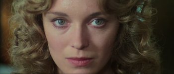 Movie still from “The House by the Cemetery” (1981), directed by Lucio Fulci – A woman's face with blue eyes; Close Up shot, High angle