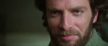 Movie still from “The House by the Cemetery” (1981), directed by Lucio Fulci – A man with a beard looking to his left; Extreme Close Up shot, Over the shoulder angle