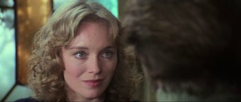 Movie still from “The House by the Cemetery” (1981), directed by Lucio Fulci – A woman's face with a monkey behind her; Close Up shot, Over the shoulder angle