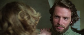 Movie still from “The House by the Cemetery” (1981), directed by Lucio Fulci – A man and a woman looking in the same direction; Close Up shot, Over the shoulder angle