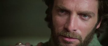 Movie still from “The House by the Cemetery” (1981), directed by Lucio Fulci – A man with a beard; Extreme Close Up shot, Low angle