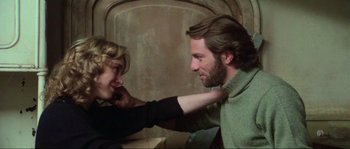 Movie still from “The House by the Cemetery” (1981), directed by Lucio Fulci – A man and a woman are looking at each other; Close Up shot, Low angle