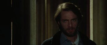 Movie still from “The House by the Cemetery” (1981), directed by Lucio Fulci – A person wearing a tie; Close Up shot, Over the shoulder angle