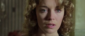 Movie still from “The House by the Cemetery” (1981), directed by Lucio Fulci – A woman's face in a black shirt; Close Up shot, Low angle