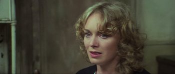 Movie still from “The House by the Cemetery” (1981), directed by Lucio Fulci – A person with curly blonde hair; Close Up shot, Over the shoulder angle