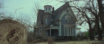 Movie still from “The House by the Cemetery” (1981), directed by Lucio Fulci – An old house in the middle of a field; Wide shot, Low angle