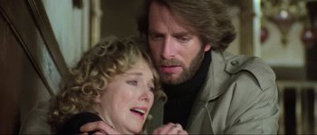 Movie still from “The House by the Cemetery” (1981), directed by Lucio Fulci – A man and a woman are crying in a room; Close Up shot, Low angle