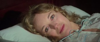 Movie still from “The House by the Cemetery” (1981), directed by Lucio Fulci – A person laying in a hospital bed; Close Up shot, High angle